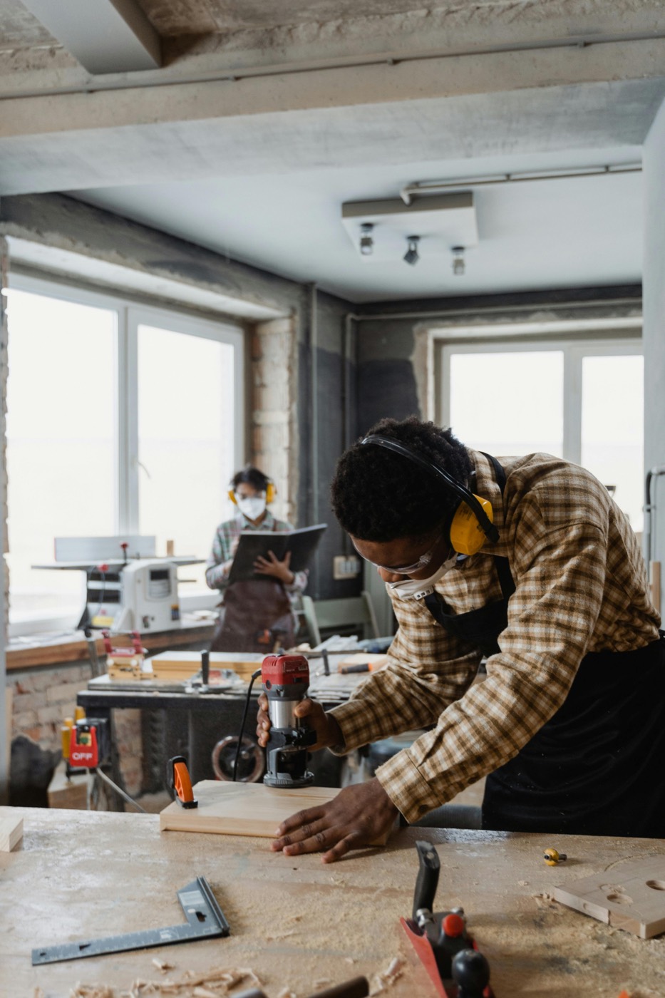Carpenter shaping wood in a workshop