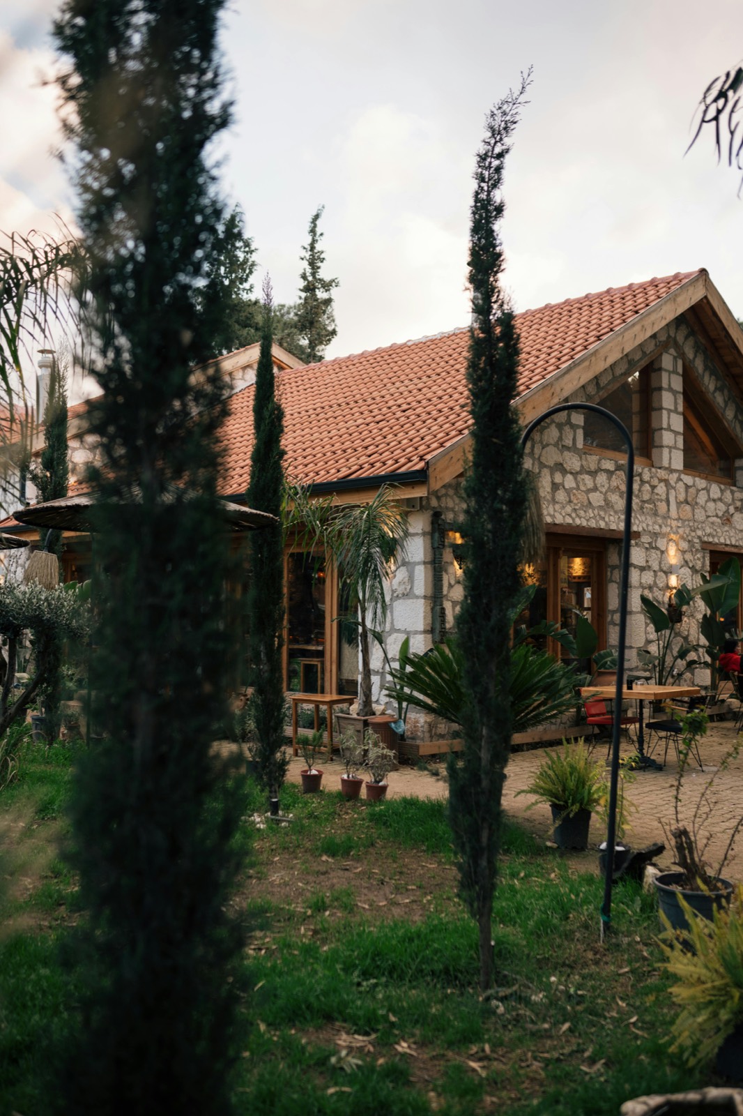 Rustic stone home exterior framed by landscaping