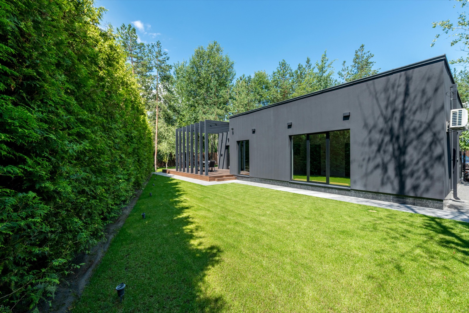 Modern custom home exterior with a landscaped yard